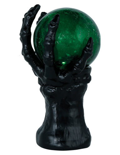 Main squelette noire avec boule de cristal lumineuse